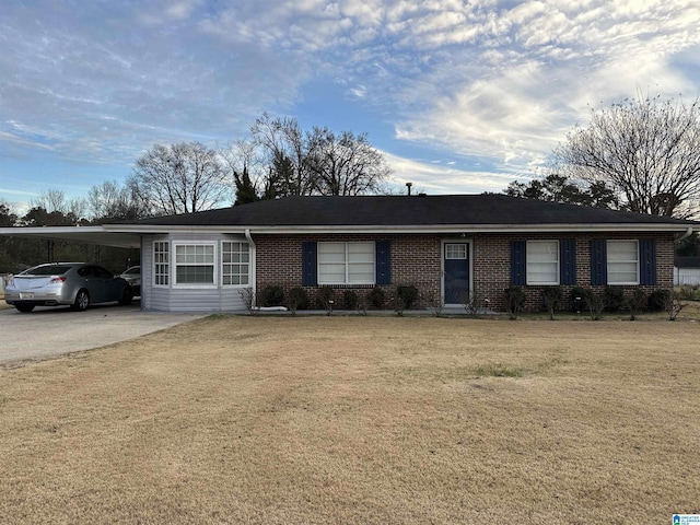 ranch-style home featuring a front yard and a carport