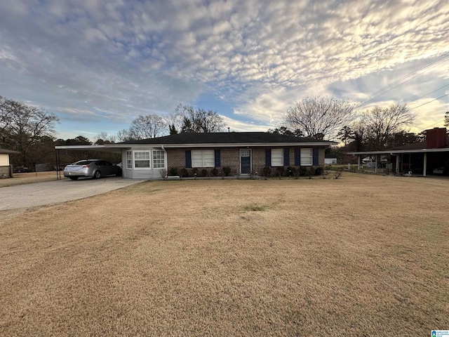 ranch-style home featuring a yard and a carport