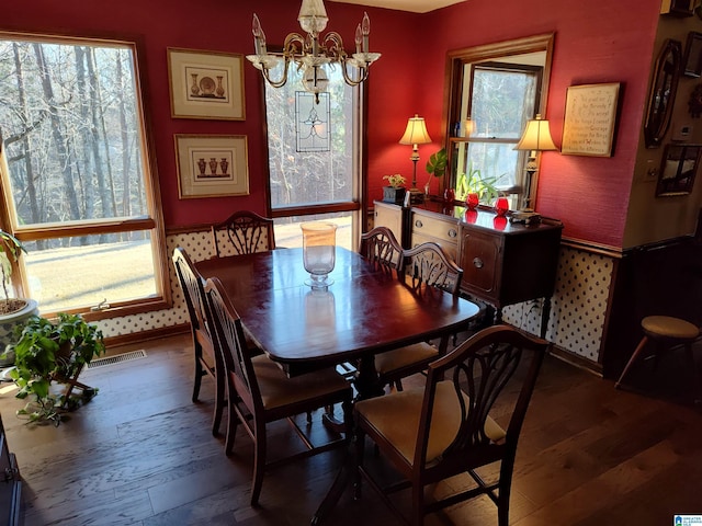 dining room with a chandelier and dark hardwood / wood-style floors