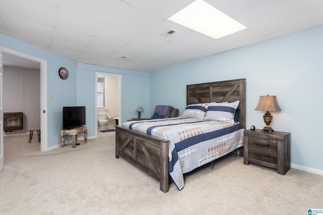 bedroom with light carpet, baseboards, visible vents, and heating unit