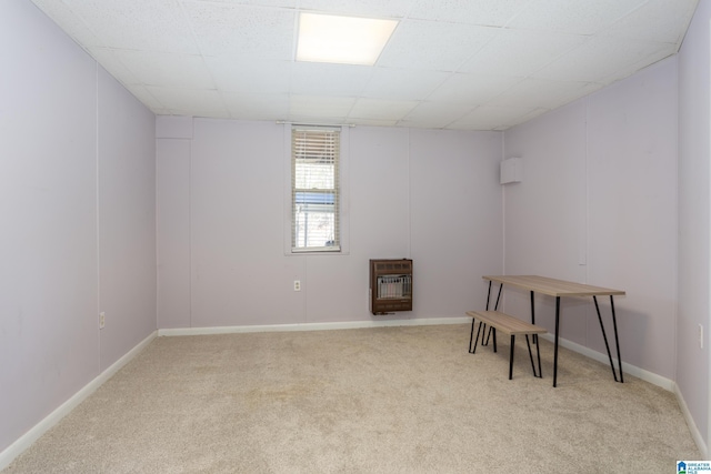 unfurnished room with heating unit and light carpet