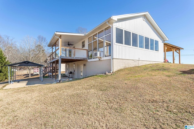 view of home's exterior with a lawn, ceiling fan, stairway, cooling unit, and a patio area