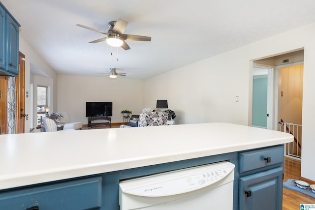 kitchen with blue cabinetry, ceiling fan, hardwood / wood-style floors, and white dishwasher