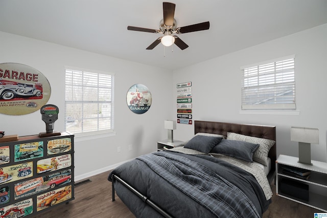 bedroom with ceiling fan and dark wood-type flooring