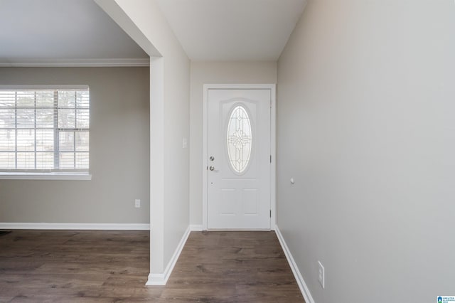 entryway featuring dark hardwood / wood-style flooring and ornamental molding