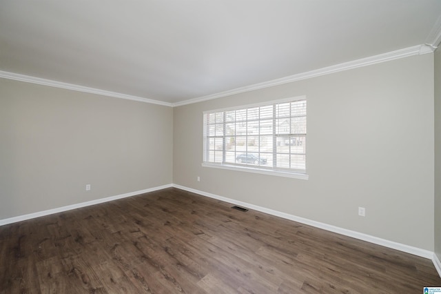 empty room featuring crown molding and dark wood-type flooring