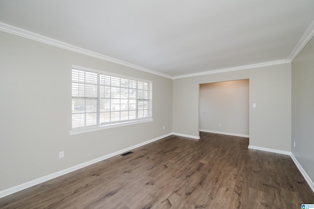 empty room with crown molding and dark hardwood / wood-style flooring