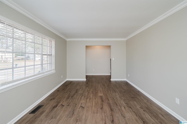 unfurnished room with dark wood-type flooring, a wealth of natural light, and ornamental molding