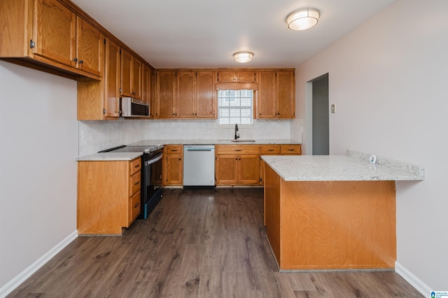 kitchen with dishwashing machine, dark hardwood / wood-style floors, kitchen peninsula, and black / electric stove