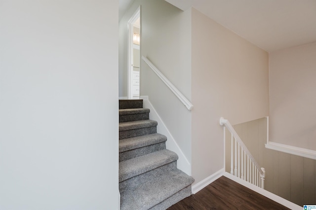 stairs featuring hardwood / wood-style floors