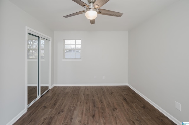 unfurnished bedroom featuring a closet, ceiling fan, and dark wood-type flooring