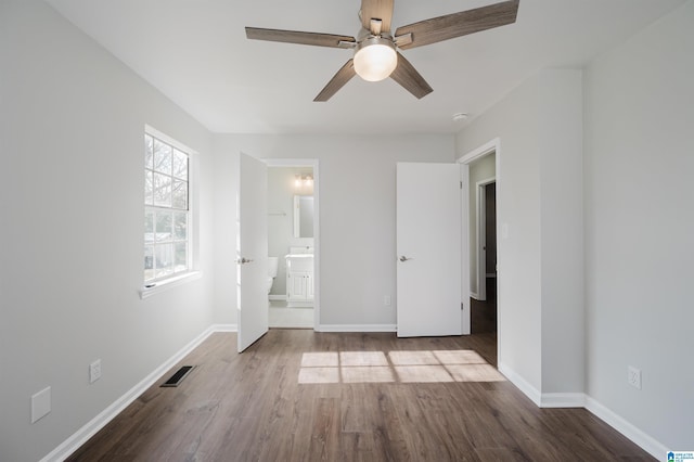 unfurnished bedroom with hardwood / wood-style flooring, ensuite bathroom, and ceiling fan