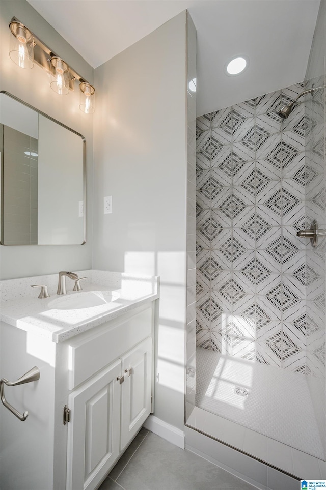 bathroom with tile patterned floors, vanity, and walk in shower