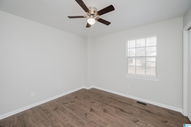 spare room with ceiling fan and dark hardwood / wood-style flooring