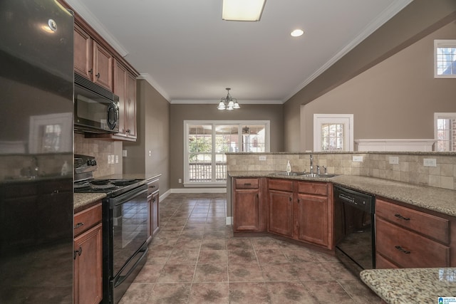 kitchen with light stone countertops, sink, a notable chandelier, and black appliances