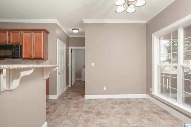 kitchen featuring a kitchen breakfast bar, crown molding, and a chandelier