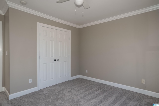 unfurnished bedroom with carpet flooring, ceiling fan, crown molding, and a closet