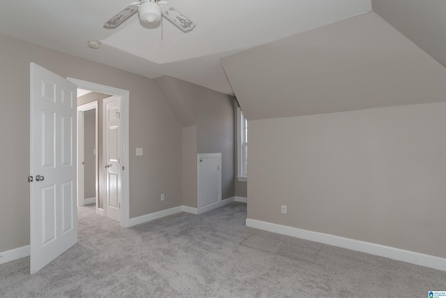 additional living space with ceiling fan, light carpet, and lofted ceiling