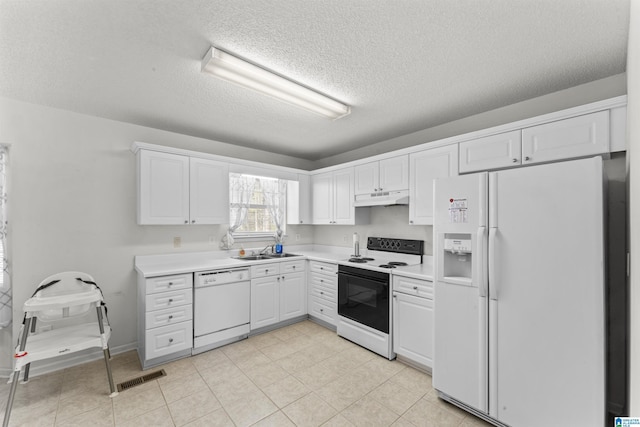 kitchen with white cabinets, sink, white appliances, and a textured ceiling