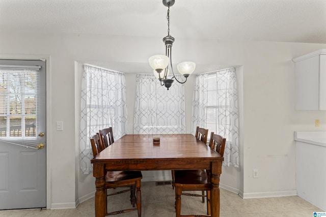 dining space featuring a textured ceiling and an inviting chandelier