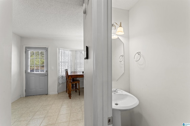 bathroom featuring sink and a textured ceiling