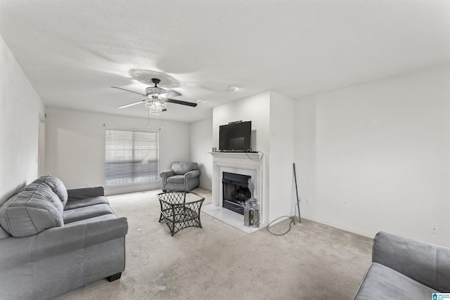 carpeted living room featuring a textured ceiling and ceiling fan