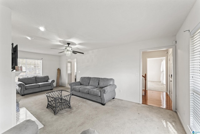 carpeted living room featuring ceiling fan