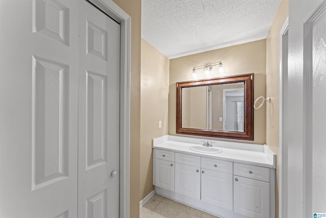 bathroom with vanity and a textured ceiling