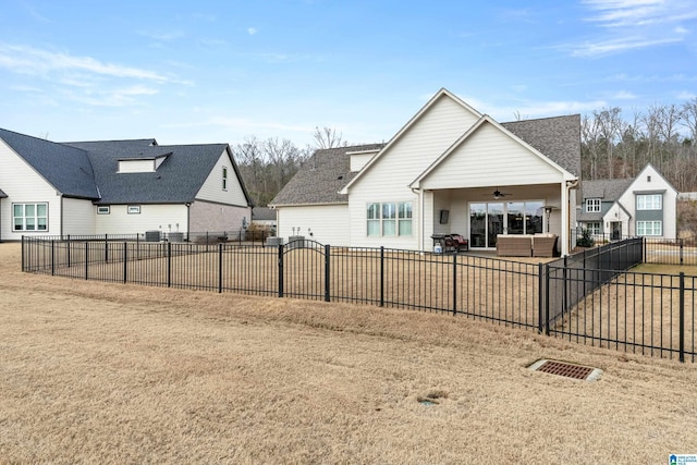 rear view of property with ceiling fan and a patio