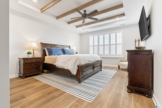 bedroom with beam ceiling, light wood-type flooring, and ceiling fan