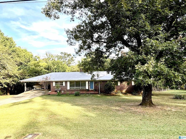 ranch-style home featuring a carport and a front yard