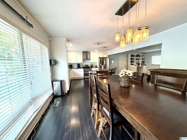 dining space with crown molding, dark hardwood / wood-style flooring, and a notable chandelier