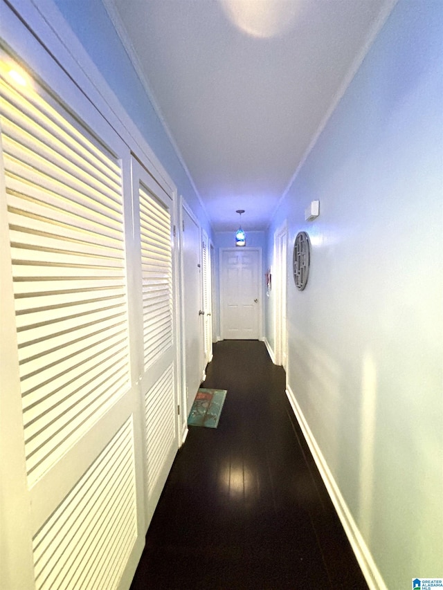 hallway with dark hardwood / wood-style flooring