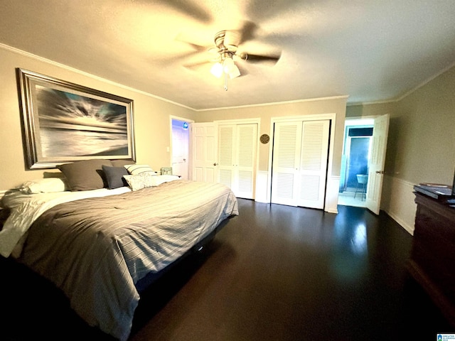 bedroom with ornamental molding, connected bathroom, ceiling fan, and multiple closets