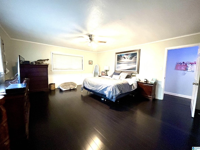 bedroom featuring ceiling fan, crown molding, and dark wood-type flooring