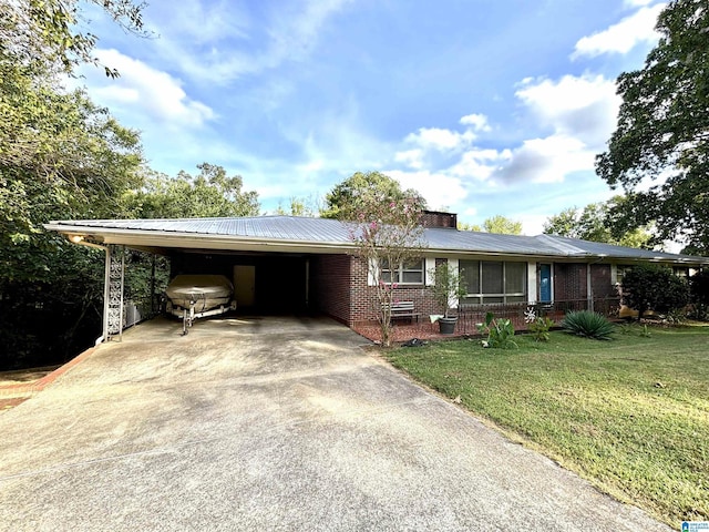 ranch-style home with a front yard and a carport