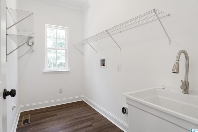 laundry room featuring hookup for a washing machine, sink, dark hardwood / wood-style floors, and ornamental molding