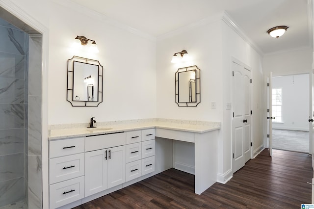 bathroom with vanity, hardwood / wood-style flooring, and crown molding