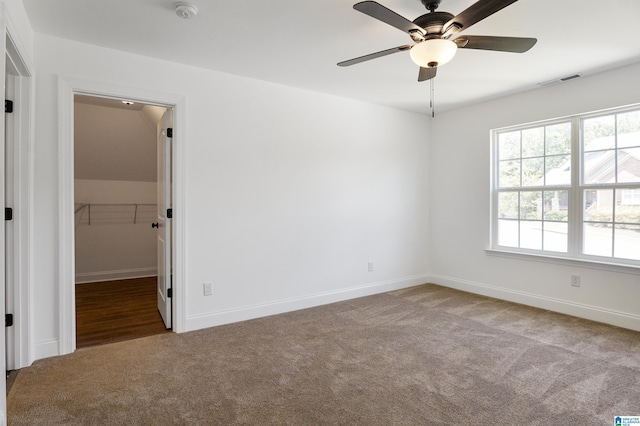 carpeted empty room featuring ceiling fan