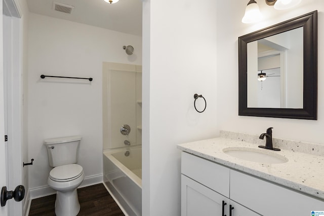 full bathroom with shower / bath combination, vanity, hardwood / wood-style flooring, and toilet