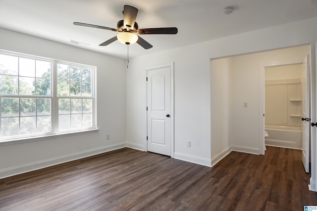 unfurnished bedroom with ceiling fan, dark hardwood / wood-style floors, and ensuite bath