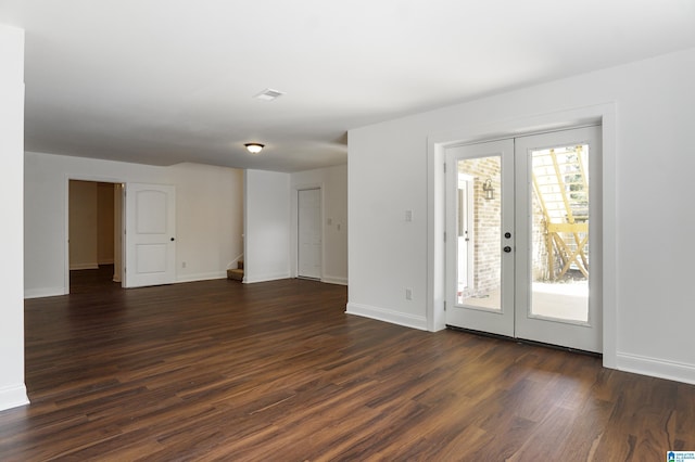 empty room with dark wood-type flooring and french doors