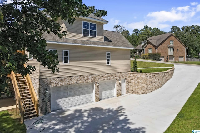 view of property exterior with a garage and a yard