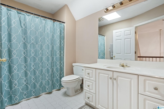 bathroom with tile patterned floors, vanity, toilet, and a skylight