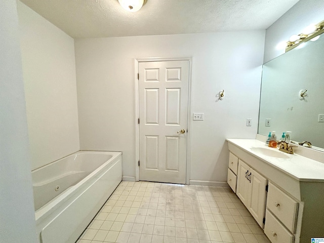 bathroom with vanity, a bath, and a textured ceiling