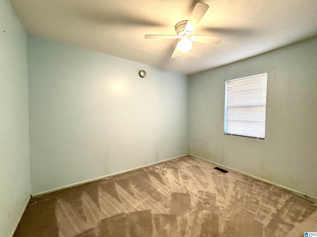 carpeted empty room featuring ceiling fan