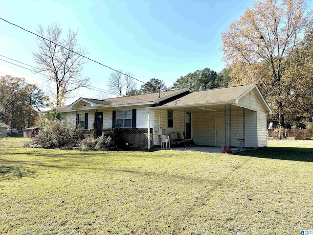 view of front of property with a carport and a front lawn