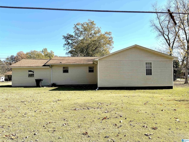 rear view of property with a yard