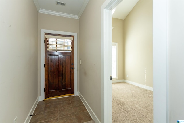 entrance foyer with dark carpet and ornamental molding