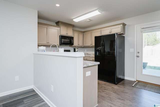 kitchen featuring kitchen peninsula, dark hardwood / wood-style floors, and black appliances